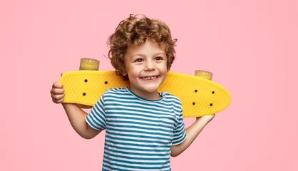 Fotobehang Skateboard Cheerful boy with skateboard  © kegfire