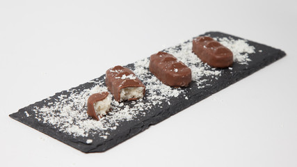 Chocolate candies with coconut flakes as filling