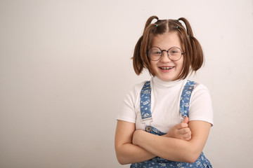 Funny fat kid girl in glasses with funny tails