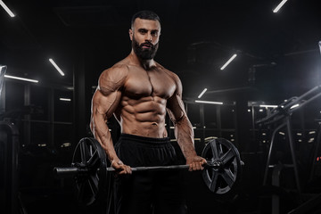 Fototapeta na wymiar Muscular man working out in gym doing exercises, strong male naked torso abs - Изображение