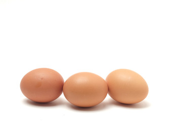 Many eggs on a white scene