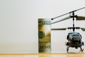 Government Military Defence Technology Abstract Background, Helicopter With Roll of US dollar Banknote, Concepts Of Modern Military Operation Cost.