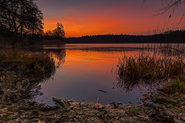 A mellow sunrise, with warm colors on a lake. Concept: postcards, calendars or travel and recreation
