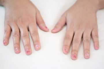 Hands placed on a white pillow