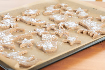 Cup of hot chocolate and homemade ginger cookies on wooden table