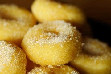 Fried donut with sugar, popular sweet  sold in market or restaurant, high calories, sugar and cholesterol level cause of many chronic disease such as diabetes and heart disease affect economic problem