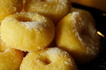 Fried donut with sugar, popular sweet  sold in market or restaurant, high calories, sugar and cholesterol level cause of many chronic disease such as diabetes and heart disease affect economic problem