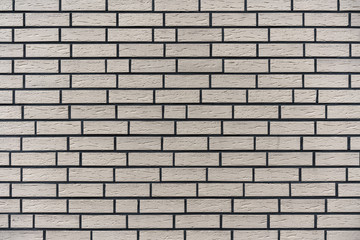 The brick exterior wall of the building is white brick.