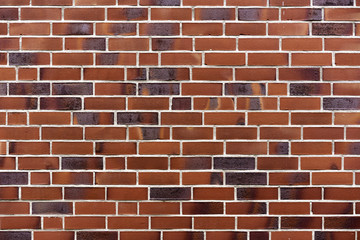 The brick wall of the building is of red terracotta color.