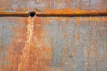 Background of rusty shell of ship at shipyard for maintenance
