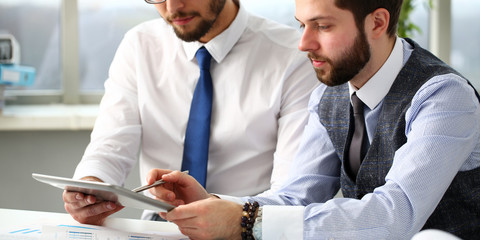 Group of businessmen point finger and silver pen in arms using electronic pad pc portrait. Financial stock market data management job remote bank or e-commerce application modern lifestyle
