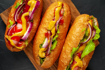 homemade hot dogs on concrete background, slate