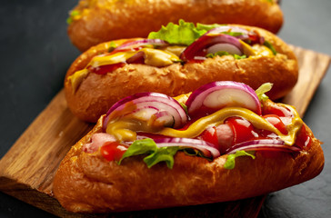 homemade hot dogs on concrete background, slate