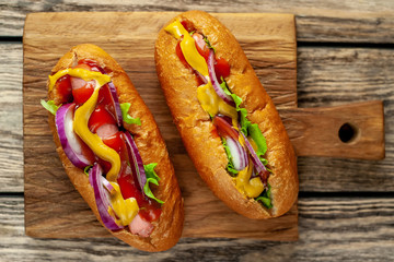 homemade hot dogs on wooden background