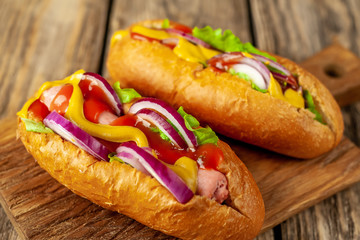 homemade hot dogs on wooden background