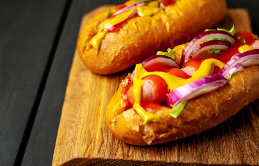 homemade hot dogs on wooden background