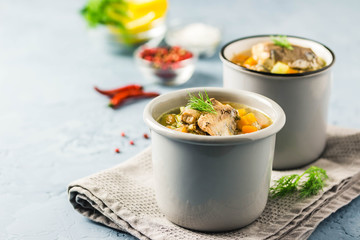 Canned fish soup with fresh herbs and lemon. Selective focus, space for text.