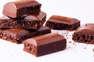 Slices of porous chocolate on a light background. Macro