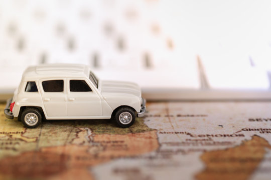 Technology, Business, Transportation and travel concept. Miniature car toy model on world map with computer keyboard.