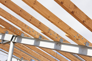 Wooden beams on a metal frame. Construction of agricultural buildings. The construction of the barn. Agriculture.
