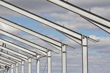 The structure of the building. Steel construction on the sky background. Electroplate steel metal....