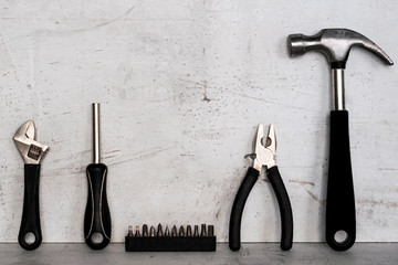 Construction tools are located on a light concrete background.