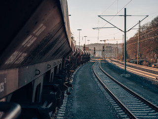 a rusty old cargo train with a red vintage look on a sidetrack