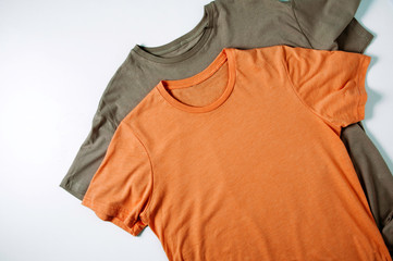 Orange t-shirt on a pale background. Template for text or design