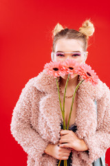 Blonde woman with nice hairstyle smelling nice flowers