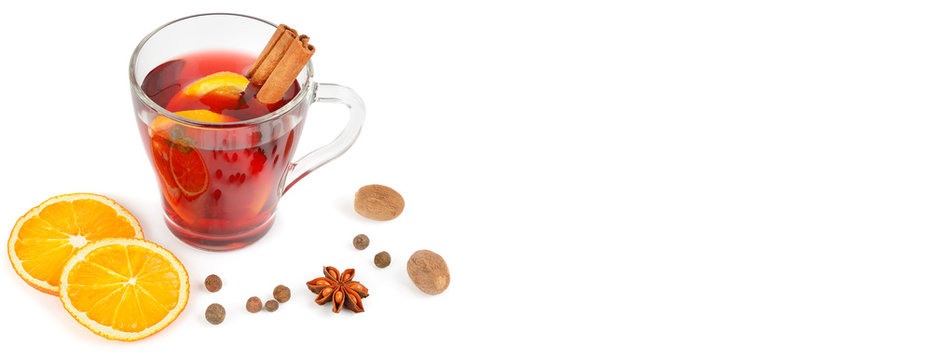 Mulled wine isolated on white background with spices, orange slice, anise and cinnamon sticks, close up. Flat lay. Free space for text. Wide photo