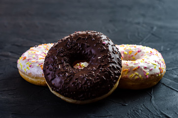multi-colored donuts on a dark background