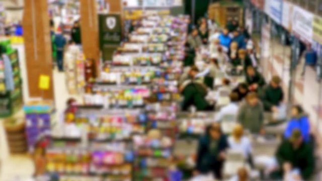 Cashier at supermarket / Retail checkout / Paying groceries. Unrecognizable buyers with carts move in queues to pay for purchases at the supermarket cashier. Fast motion.