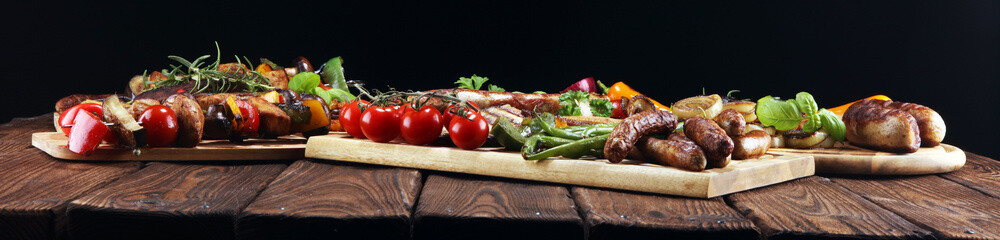 Assorted delicious grilled meat with vegetable on rustic table - Powered by Adobe