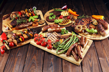 Assorted delicious grilled meat with vegetable on rustic table