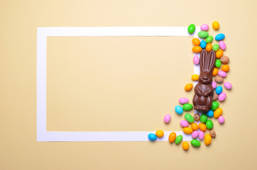 Easter Bunny and Chocolate Eggs on Bright Background