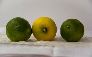 limes and lemons on a tablecloth