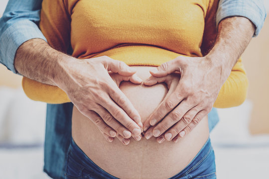 Close up of future father that embracing wife