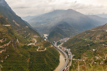Fototapeta na wymiar highway passes in a gorge in the mountains along the river, Heng River, Yunnan Province, China