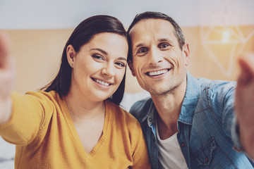 Cheerful brunette woman sitting near her man