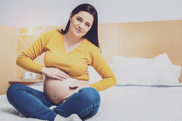 Delighted pregnancy feeling movements of her baby