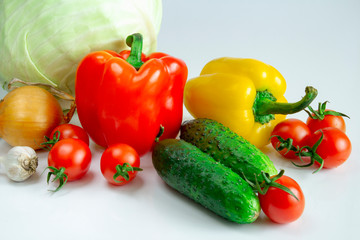 Bulgarian pepper tomatoes cabbage cucumbers onions and garlic on a white background