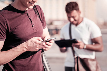 Close up of male hands that holding telephone