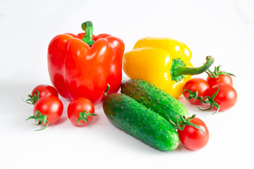 Bulgarian pepper with tomatoes and cucumbers on a white background