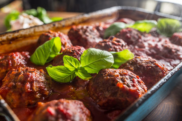 Delisious italian meal meat beef balls with basil in vintage roaster pan.