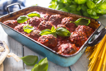 Delisious italian meal meat beef balls with pasta spaghetti and basil in vintage roaster pan