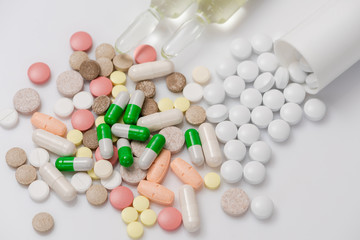 Medicine pills or capsules on white background.