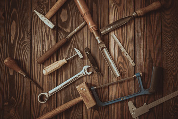 Carpenter's tools on a wooden background with eyes