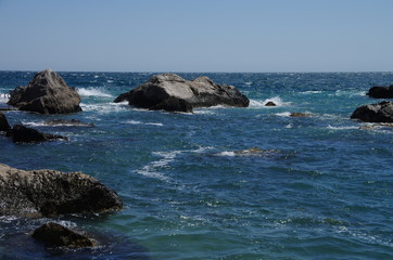 Fototapeta na wymiar Large stones of frozen lava on the beach in Foros, Crimea.