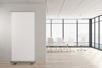 Modern meeting room with empty billboard