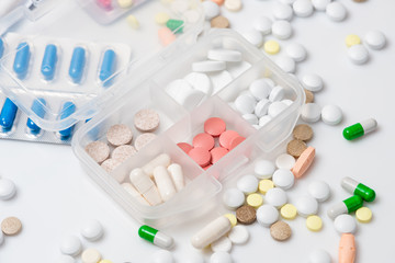 Close-up of pill case with various medications